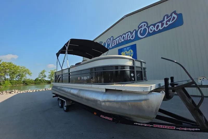 Slide: The Image of 2015 Crest III 230 SL pontoon boat on trailer at Clemons Boats dealership. - 2