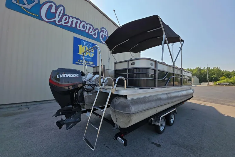Slide: The Image of 2015 Crest III 230 SL pontoon boat with Evinrude motor, parked outside Clemons Boats. - 4