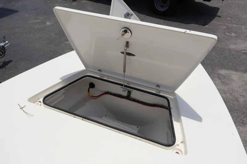 Slide: The Image of Open storage compartment on 2026 Hewes Redfisher 18 boat deck. - 10
