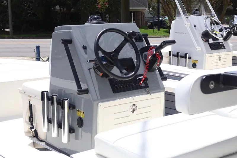 Slide: The Image of 2026 Hewes Redfisher 18 boat console with steering wheel and controls. - 4