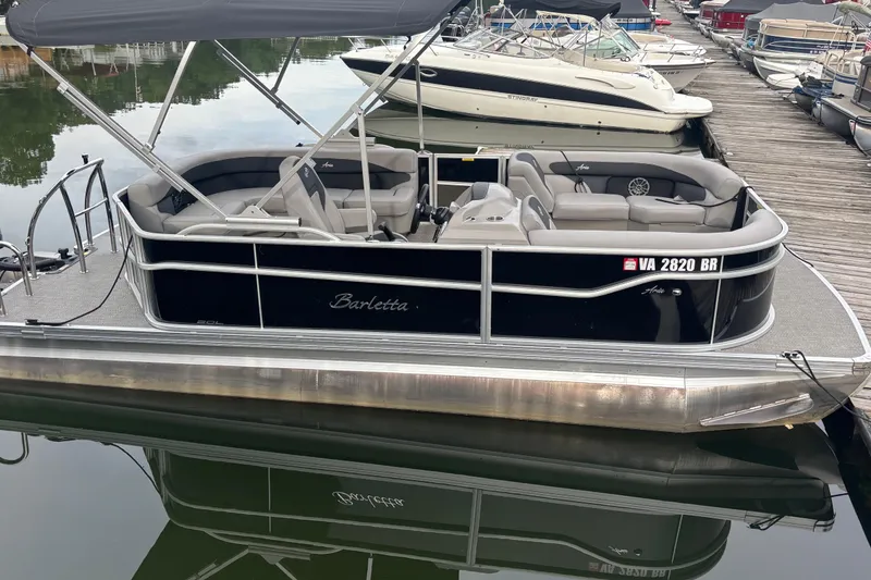 The Image of 2025 Barletta Aria 20L pontoon boat docked at marina. - 0