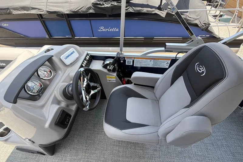 Slide: The Image of 2025 Barletta Aria 20L boat cockpit with steering wheel and comfortable captain's chair. - 3