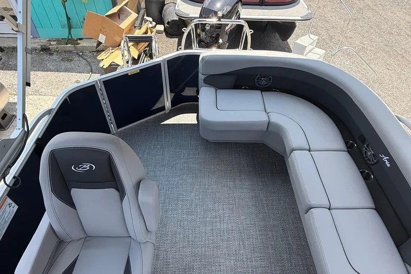 Slide: The Image of 2025 Barletta Aria 20L pontoon boat interior with gray seating and carpeted floor. - 5