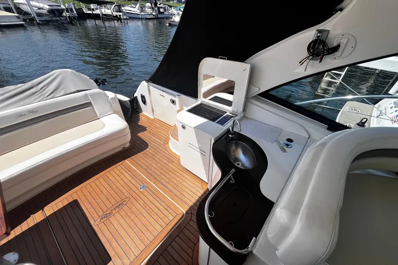 Slide: The Image of 2012 Sea Ray 500 Sundancer yacht interior with seating, sink, and water view. - 10