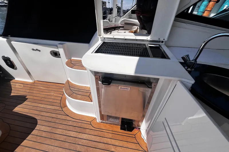 Slide: The Image of 2012 Sea Ray 500 Sundancer yacht deck with outdoor kitchen and steps. - 11