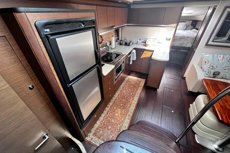 Slide: The Image of Luxurious interior of 2012 Sea Ray 500 Sundancer yacht with modern kitchen amenities. - 16