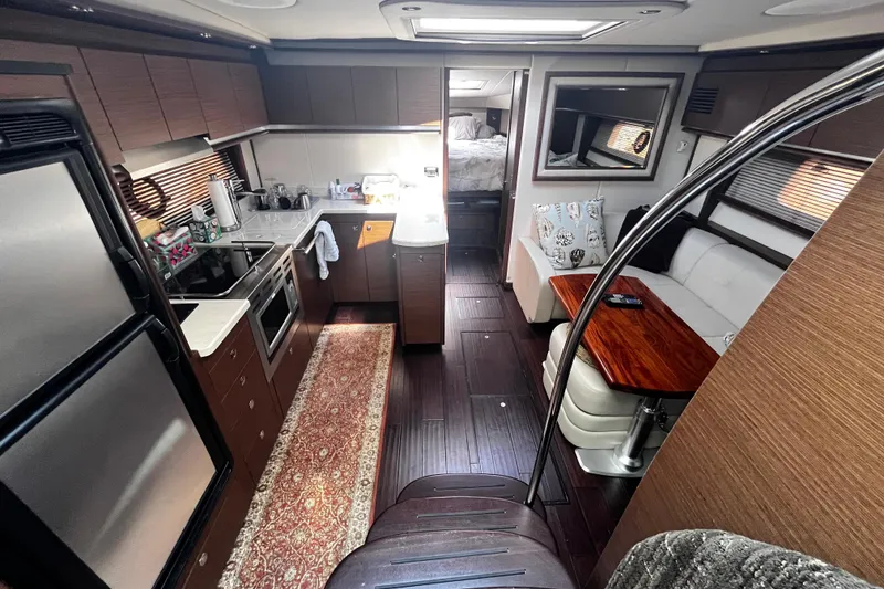 Slide: The Image of Luxurious interior of 2012 Sea Ray 500 Sundancer yacht with modern kitchen and seating area. - 17