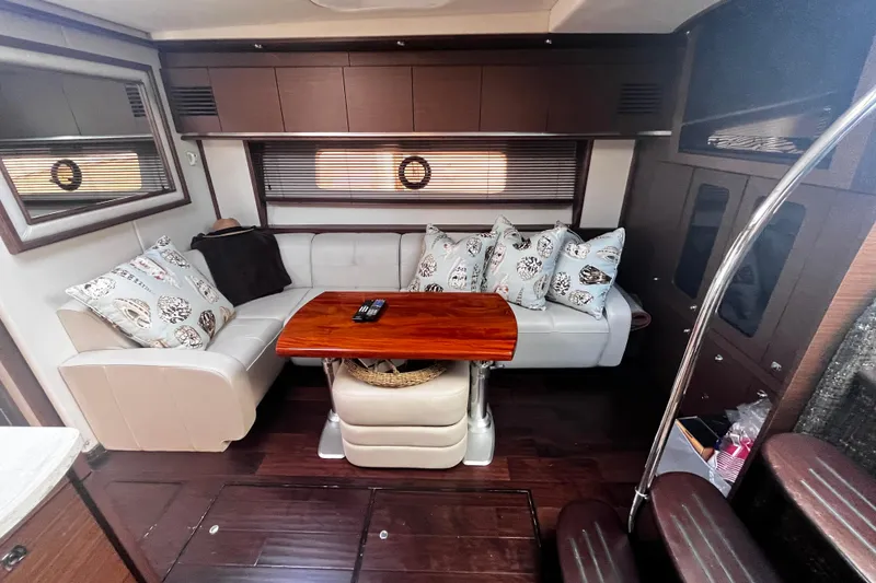 Slide: The Image of Luxurious 2012 Sea Ray 500 Sundancer interior with elegant seating and wooden table. - 19