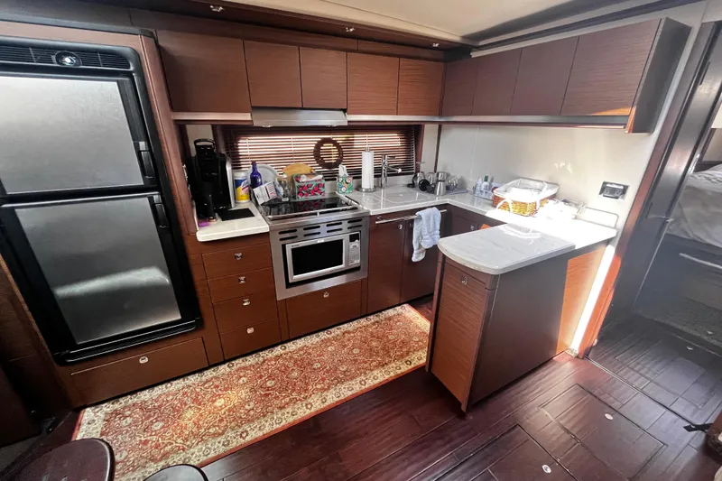 Slide: The Image of Luxurious kitchen interior of 2012 Sea Ray 500 Sundancer yacht with modern appliances. - 23