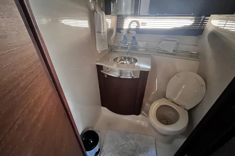 Slide: The Image of Bathroom interior of 2012 Sea Ray 500 Sundancer yacht, featuring sink and toilet. - 28
