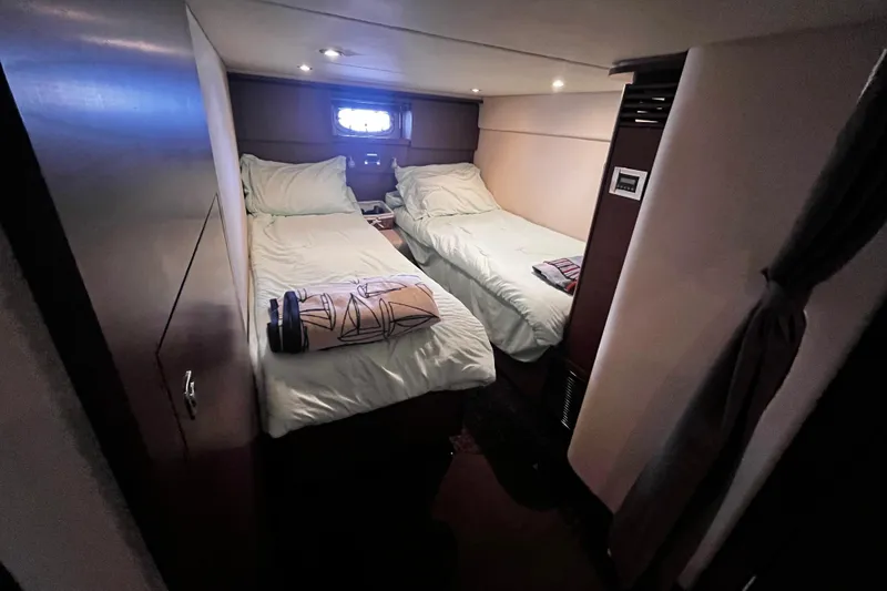 Slide: The Image of Interior cabin of 2012 Sea Ray 500 Sundancer with twin beds and cozy lighting. - 31