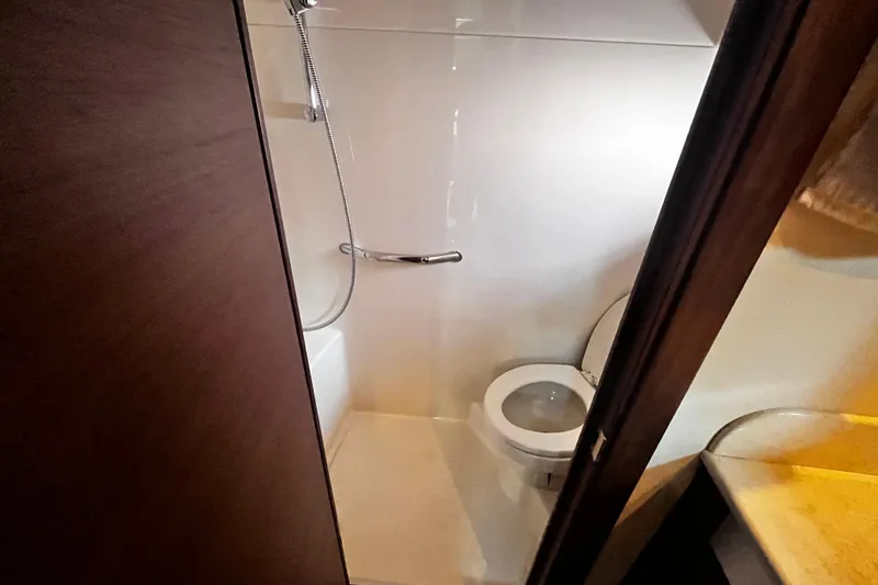 Slide: The Image of Bathroom interior of 2012 Sea Ray 500 Sundancer yacht, featuring shower and toilet. - 32