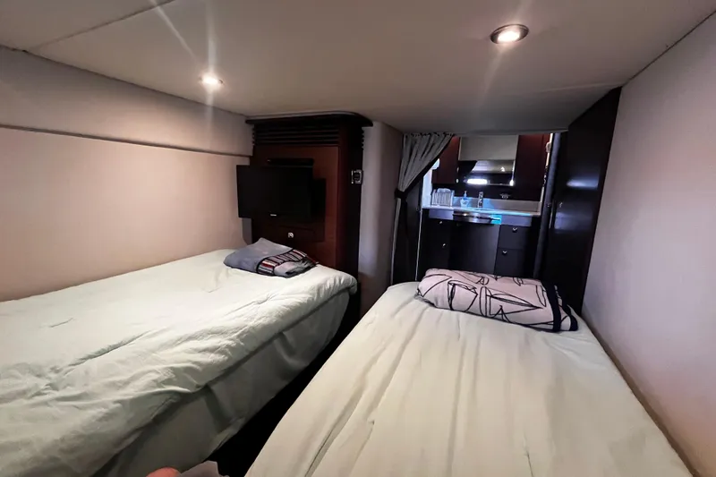 Slide: The Image of Interior cabin of 2012 Sea Ray 500 Sundancer yacht with twin beds and TV. - 33