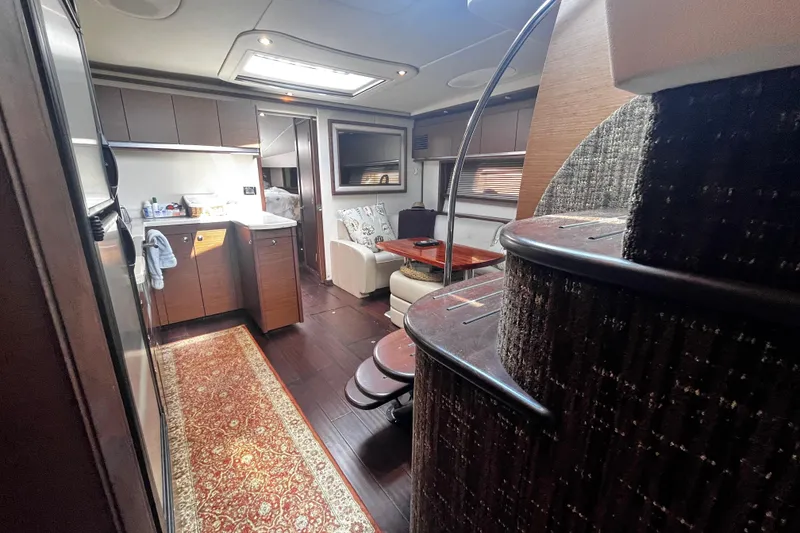 Slide: The Image of Luxurious interior of 2012 Sea Ray 500 Sundancer yacht with modern kitchen and seating area. - 34