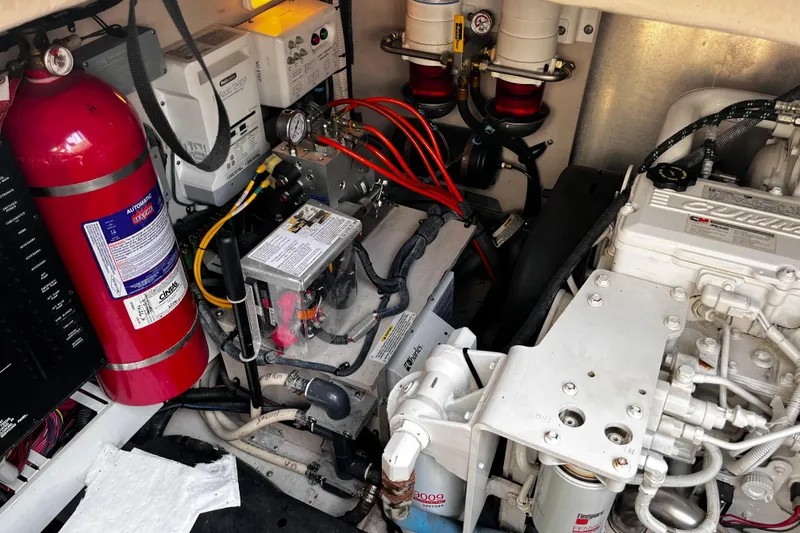 Slide: The Image of Engine room of 2012 Sea Ray 500 Sundancer with fire extinguisher and mechanical components. - 39