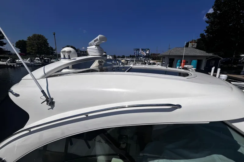 Slide: The Image of 2012 Sea Ray 500 Sundancer yacht docked at marina under clear blue sky. - 4