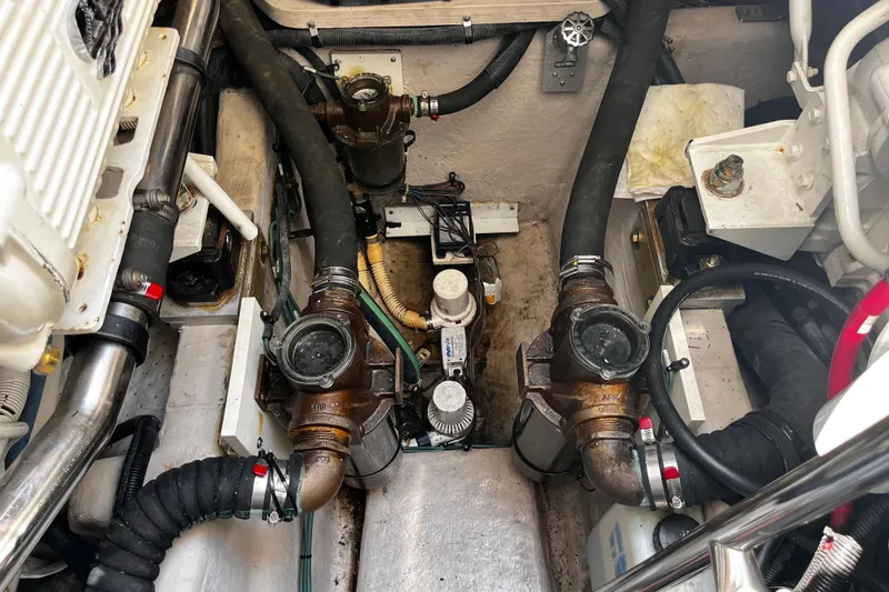 Slide: The Image of Engine room of a 2012 Sea Ray 500 Sundancer, showcasing mechanical components and hoses. - 40