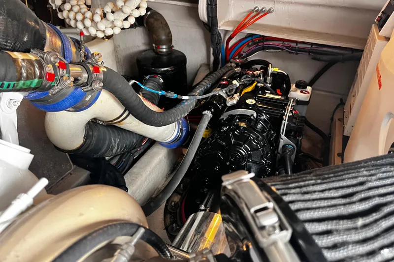 Slide: The Image of Engine compartment of 2012 Sea Ray 500 Sundancer with visible hoses and components. - 41