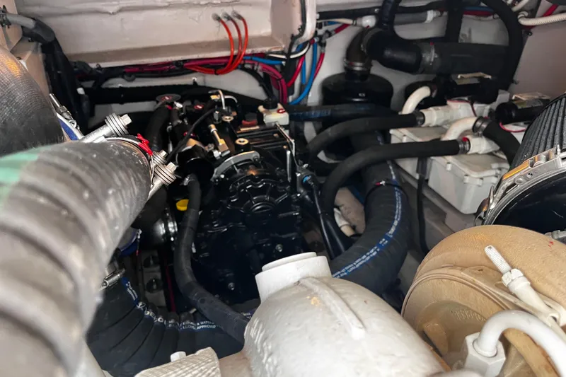 Slide: The Image of Engine compartment of a 2012 Sea Ray 500 Sundancer with visible hoses and components. - 42