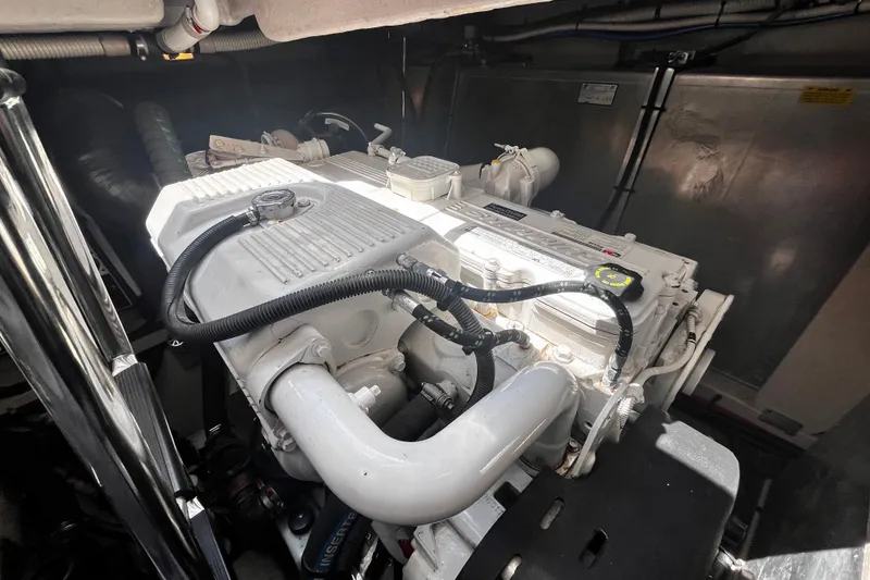Slide: The Image of Engine compartment of a 2012 Sea Ray 500 Sundancer yacht, showcasing detailed machinery. - 43