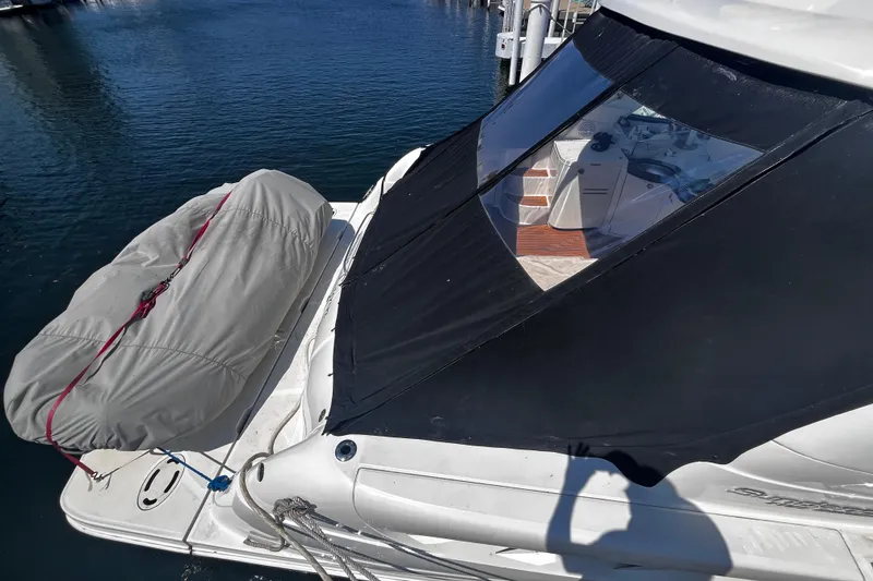 Slide: The Image of 2012 Sea Ray 500 Sundancer yacht with covered seating area, docked on calm water. - 5