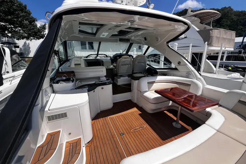 Slide: The Image of Luxurious 2012 Sea Ray 500 Sundancer yacht interior with elegant seating and wooden flooring. - 8