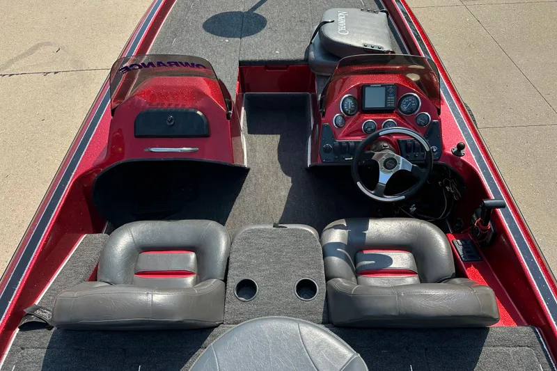 Slide: The Image of Interior of a 1999 Champion 193 DCX boat with red dashboard and leather seats. - 10