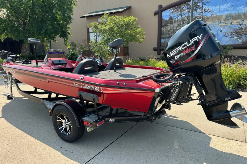Slide: The Image of Red 1999 Champion 193 DCX boat with Mercury OptiMax engine on trailer. - 3