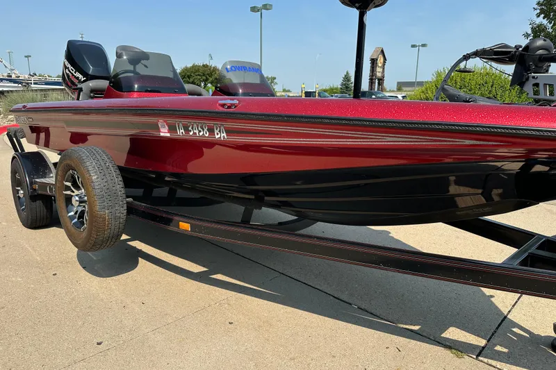 Slide: The Image of Red 1999 Champion 193 DCX boat on trailer, featuring Mercury engine and Lowrance equipment. - 4