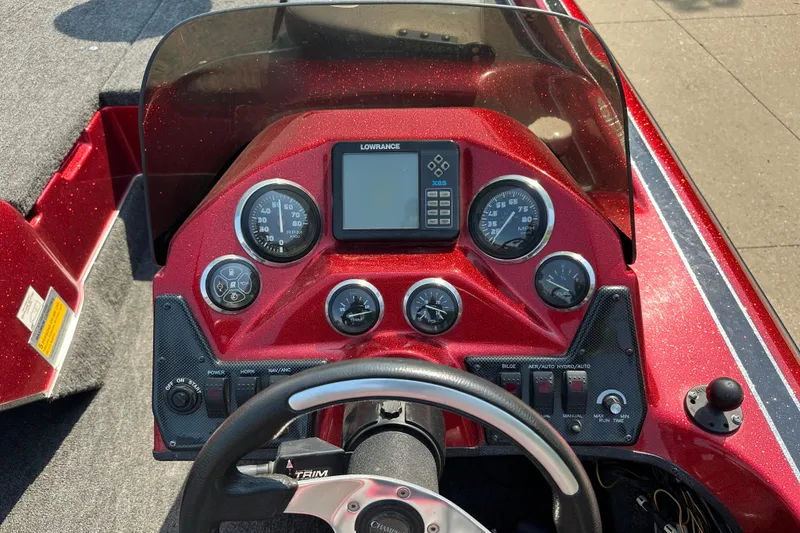 Slide: The Image of Dashboard of a 1999 Champion 193 DCX boat with gauges and controls. - 6