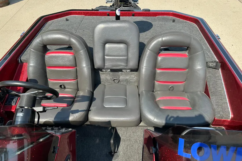 Slide: The Image of Interior of a 1999 Champion 193 DCX boat with gray and red seats. - 8
