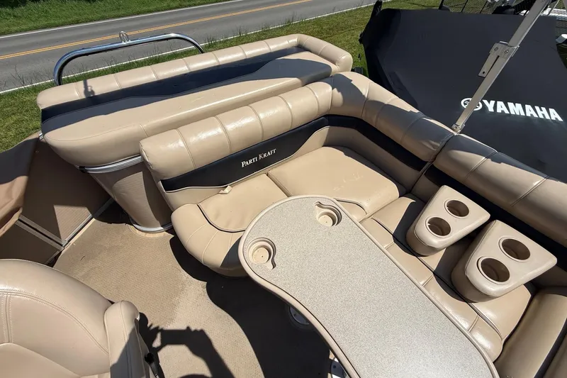 Slide: The Image of 2004 Parti Kraft Admiral 220 RE pontoon boat interior with beige seating and cup holders. - 15