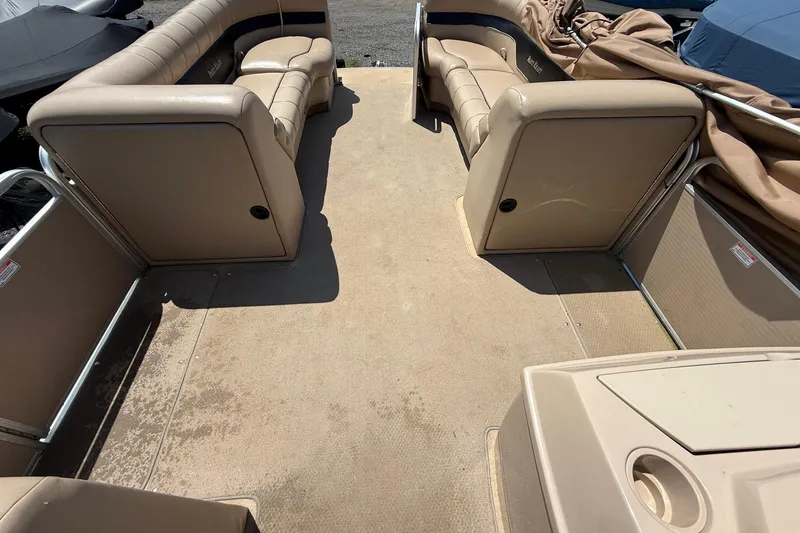 Slide: The Image of 2004 Parti Kraft Admiral 220 RE pontoon boat interior with beige seating and spacious deck. - 16