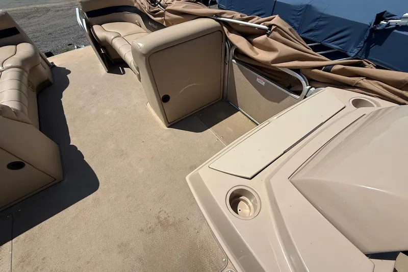 Slide: The Image of 2004 Parti Kraft Admiral 220 RE pontoon boat interior with beige seating and storage compartments. - 17