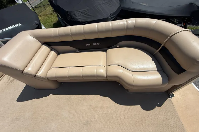 Slide: The Image of 2004 Parti Kraft Admiral 220 RE boat seating, beige upholstery, outdoor setting. - 19