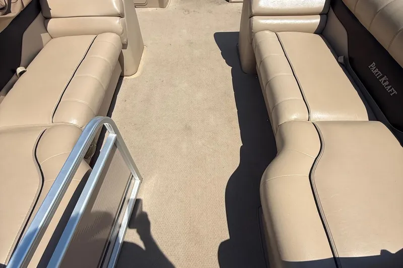 Slide: The Image of 2004 Parti Kraft Admiral 220 RE boat interior with beige seating and carpet. - 20