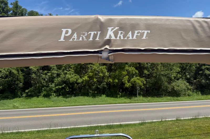 Slide: The Image of Parti Kraft Admiral 220 RE canopy with road and trees in background, 2004 model. - 21
