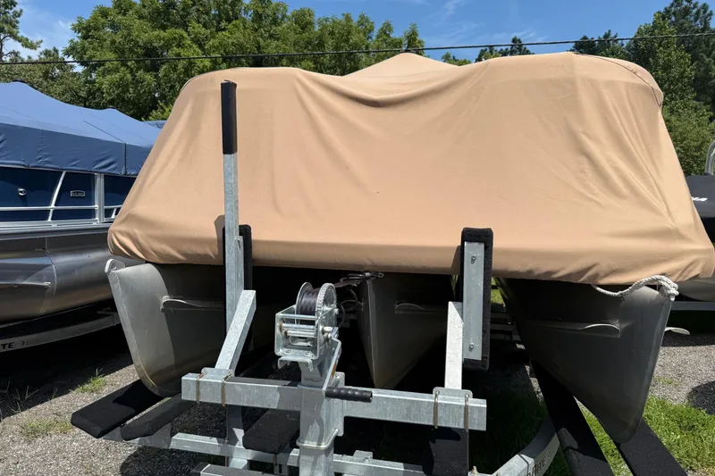 Slide: The Image of 2004 Parti Kraft Admiral 220 RE pontoon boat covered with a beige tarp on a trailer. - 28