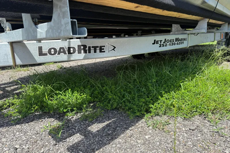 Slide: The Image of Trailer for 2004 Parti Kraft Admiral 220 RE, Load Rite brand, on grassy surface. - 29