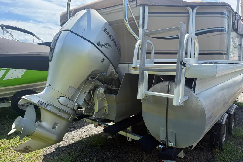 Slide: The Image of 2004 Parti Kraft Admiral 220 RE pontoon boat with Honda outboard motor, docked on grass. - 3