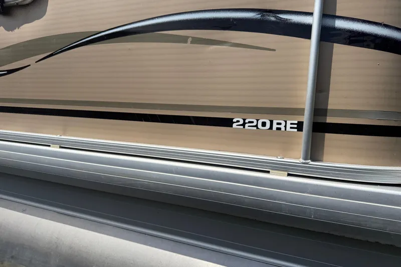 Slide: The Image of 2004 Parti Kraft Admiral 220 RE pontoon boat with sleek design and metallic accents. - 5