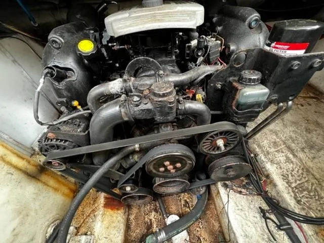 Slide: The Image of Engine of a 2010 Larson Cabrio 274 boat, showing belts and components. - 10