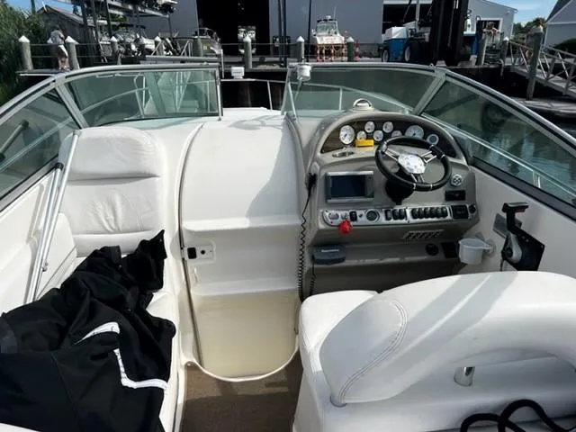 Slide: The Image of 2010 Larson Cabrio 274 boat interior with steering wheel and dashboard controls. - 12