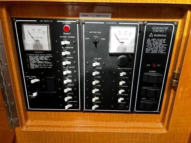 Slide: The Image of Electrical control panel on a 2010 Larson Cabrio 274 boat, featuring various switches and gauges. - 24