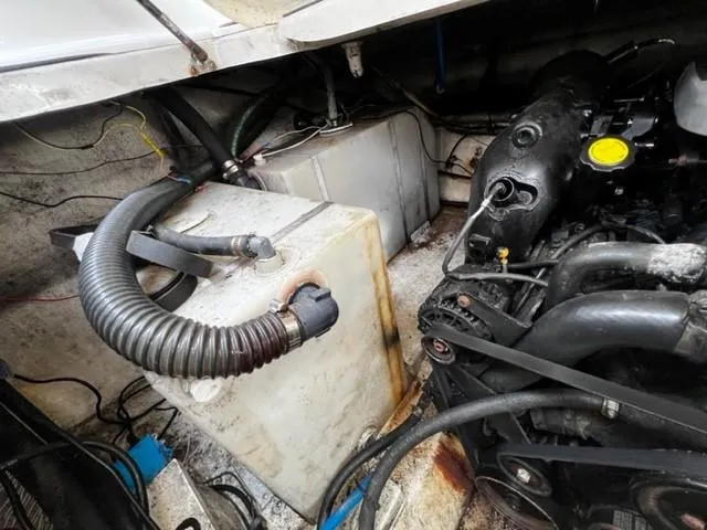 Slide: The Image of Engine compartment of a 2010 Larson Cabrio 274 boat, showing hoses and components. - 33
