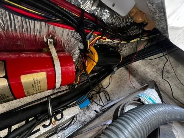 Slide: The Image of Engine compartment of a 2010 Larson Cabrio 274 boat with wiring and fire extinguisher. - 34