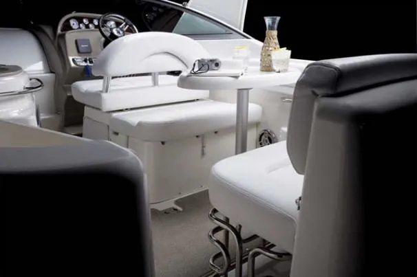 Slide: The Image of Interior of 2010 Larson Cabrio 274 boat with white seating and table. - 4