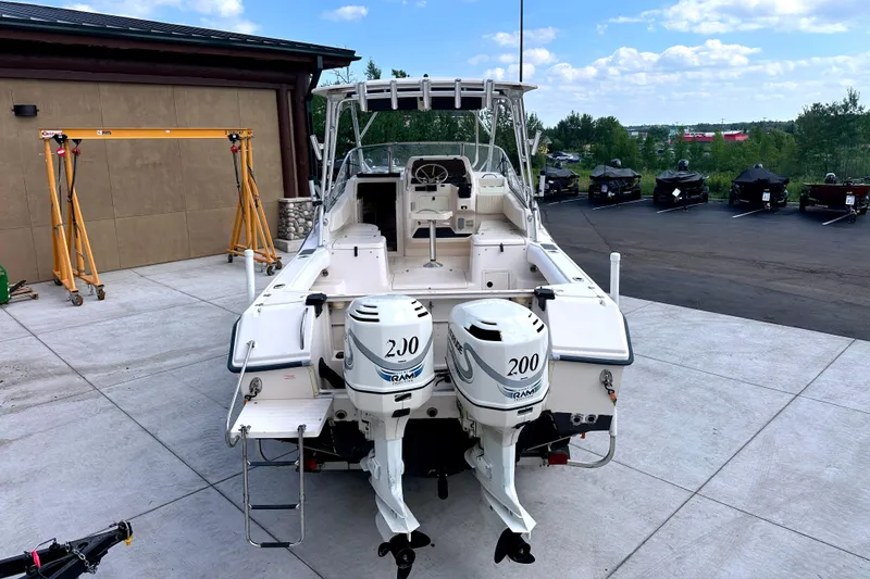 Slide: The Image of 2000 Grady-White Express 265 boat with twin outboard engines, parked outdoors. - 13
