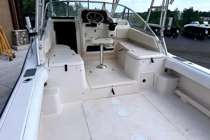 Slide: The Image of 2000 Grady-White Express 265 boat interior with seating and steering wheel. - 14