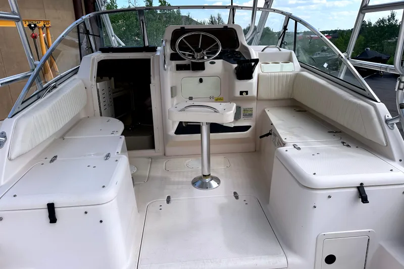 Slide: The Image of 2000 Grady-White Express 265 boat interior with seating and steering wheel. - 16